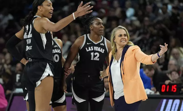 Las Vegas Aces head coach Becky Hammon, right, motions to her player during the second half of a WNBA basketball game against the Minnesota Lynx, Wednesday, Aug. 21, 2024, in Las Vegas. (AP Photo/John Locher)