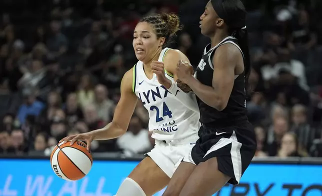 Minnesota Lynx forward Napheesa Collier (24) drives gainst Las Vegas Aces guard Jackie Young (0) during the second half of a WNBA basketball game Wednesday, Aug. 21, 2024, in Las Vegas. (AP Photo/John Locher)