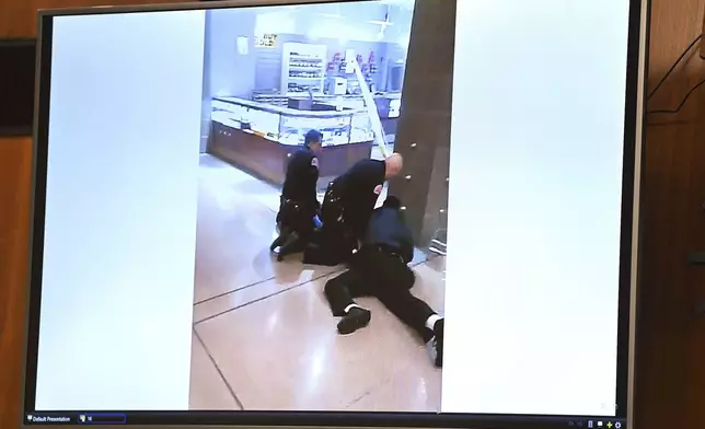 A Video shows security guards trying to detain McKenzie Cochran during the involuntary manslaughter trial of three Northland Mall security guards who were charged with killing McKenzie Cochran at the mall. Oakland County Circuit on Tuesday, Aug. 20, 2024, in Pontiac, Mich. (Clarence Tabb, Jr./Detroit News via AP)