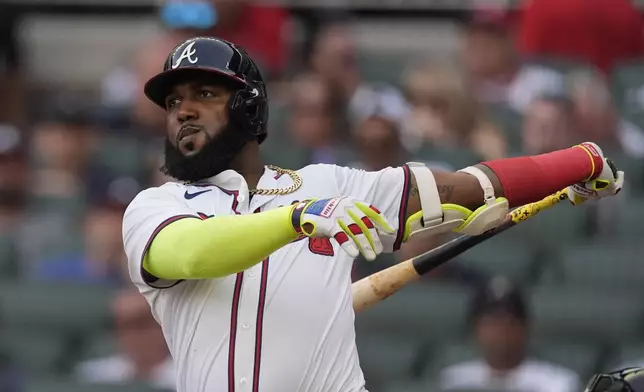 Atlanta Braves designated hitter Marcell Ozuna follows through on a base hit in the first inning of a baseball game against the Miami Marlins , Thursday, Aug. 1, 2024, in Atlanta. (AP Photo/John Bazemore)