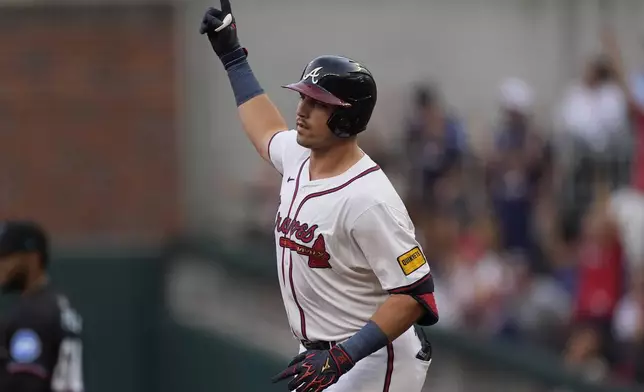 Atlanta Braves' Austin Riley gestures as he rounds the bases after hitting as solo-home rin in the first inning of a baseball game against the Miami Marlins, Thursday, Aug. 1, 2024, in Atlanta. (AP Photo/John Bazemore)