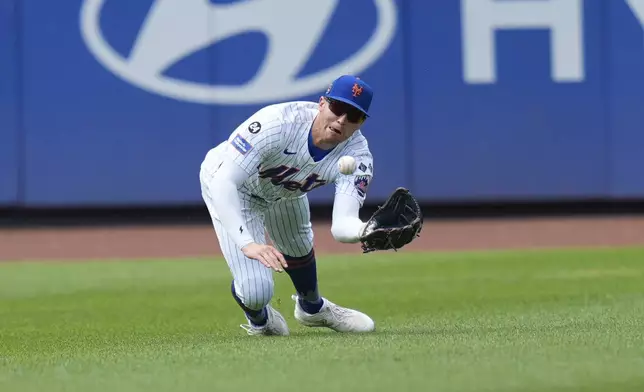 New York Mets outfielder Brandon Nimmo makes a diving catch during the seventh inning of a baseball game against the Miami Marlins at Citi Field, Sunday, Aug. 18, 2024, in New York. (AP Photo/Seth Wenig)