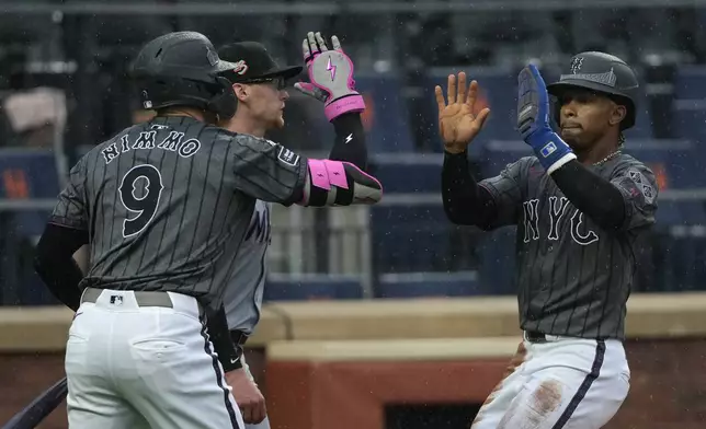 New York Mets' Brandon Nimmo, left, and Francisco Lindor, right, celebrate after Lindor scored on a double by Mark Vientos during the fourth inning of a baseball game against the Miami Marlins, Saturday, Aug. 17, 2024, in New York. (AP Photo/Pamela Smith)