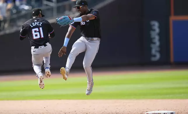 Miami Marlins' Jesús Sánchez, right, celebrates with Otto Lopez (61) after a baseball game against the New York Mets at Citi Field, Sunday, Aug. 18, 2024, in New York. (AP Photo/Seth Wenig)