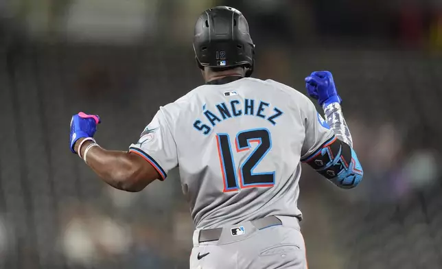 Miami Marlins' Jesus Sachez gestures as he circles the bases after hitting a three-run home run off Colorado Rockies relief pitcher Angel Chivilli in the ninth inning of after a baseball game, Tuesday, Aug. 27, 2024, in Denver. (AP Photo/David Zalubowski)