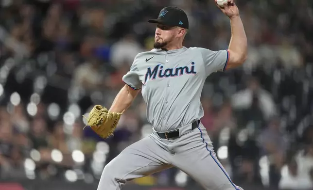 Miami Marlins relief pitcher Austin Kitchen works against the Colorado Rockies in the sixth inning of a baseball game Wednesday, Aug. 28, 2024, in Denver. (AP Photo/David Zalubowski)