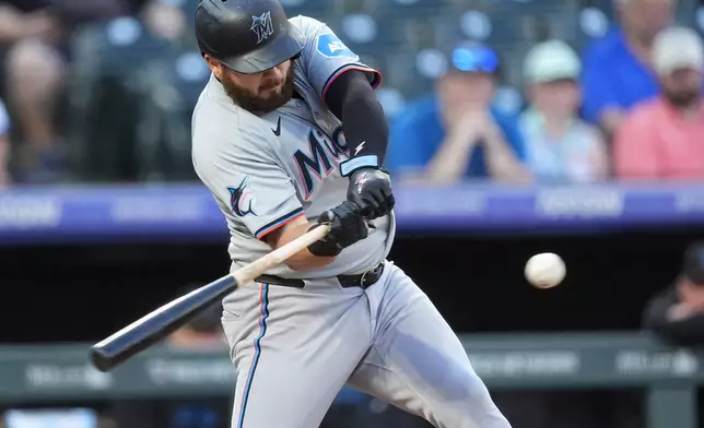 Miami Marlins' Jake Burger flies out against Colorado Rockies starting pitcher Ryan Feltner in the first inning of a baseball game Monday, Aug. 26, 2024, in Denver. (AP Photo/David Zalubowski)