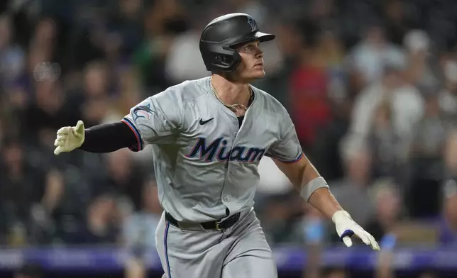 Miami Marlins' Griffin Conine heads up the first-base line after tripling against Colorado Rockies starting pitcher Cal Quantrill in the sixth inning of a baseball game Tuesday, Aug. 27, 2024, in Denver. (AP Photo/David Zalubowski)