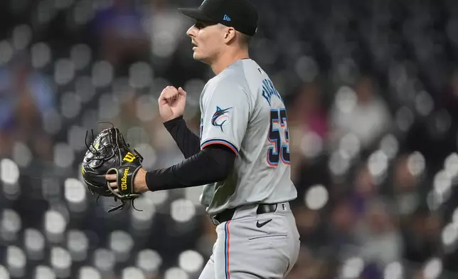 Miami Marlins relief pitcher Calvin Faucher reacts after striking out Colorado Rockies' Ryan McMahon to end in a baseball game, Tuesday, Aug. 27, 2024, in Denver. (AP Photo/David Zalubowski)