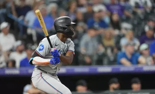 Miami Marlins' Jesús Sanchez follows the flight of his single off Colorado Rockies starting pitcher Ryan Feltner to rive in two runs in the fifth inning of a baseball game Monday, Aug. 26, 2024, in Denver. (AP Photo/David Zalubowski)