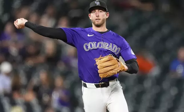 Colorado Rockies third baseman Ryan McMahon throws to first base to put out Miami Marlins' Nick Fortes in the seventh inning of a baseball game, Monday, Aug. 26, 2024, in Denver. (AP Photo/David Zalubowski)