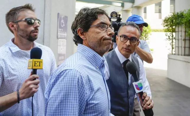 Dr. Mark Chavez, center, a physician from San Diego, who is charged in connection with actor Matthew Perry's death from an accidental ketamine overdose, arrives at the Roybal Federal Courthouse in Los Angeles, Friday, Aug. 30, 2024. (AP Photo/Damian Dovarganes)