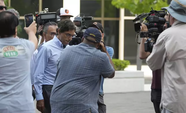 Dr. Mark Chavez, a physician from San Diego, who is charged in connection with actor Matthew Perry's death from an accidental ketamine overdose, is surrounded by members of the media as he arrives at the Roybal Federal Courthouse in Los Angeles, Friday, Aug. 30, 2024. (AP Photo/Damian Dovarganes)