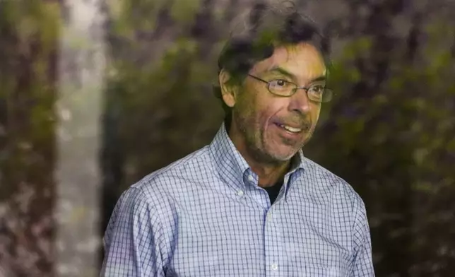 Dr. Mark Chavez, a physician from San Diego, charged in connection with actor Matthew Perry's death from an accidental ketamine overdose, is seen through a glass window as he arrives at the Roybal Federal Courthouse in Los Angeles, Friday, Aug. 30, 2024. (AP Photo/Damian Dovarganes)