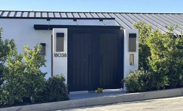 FILE - Flowers appear outside the home of actor Matthew Perry in Los Angeles on Oct. 29, 2023, a day after his death. A prosecutor says five people have been charged in connection with Perry’s death, including the actor’s assistant and two doctors. (AP Photo/Eugene Garcia, File)