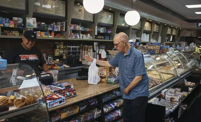 Ron Spitzer, a stroke survivor, right, shops, on Monday, July 15, 2024, in New York. (AP Photo/Andres Kudacki)