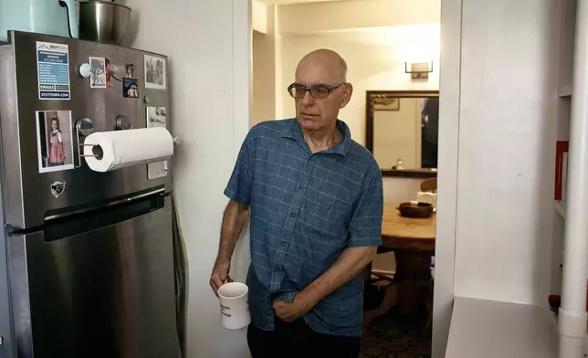 Ron Spitzer, stroke survivor, walks into his kitchen holding a cup of coffee, on Monday, July 15, 2024, in New York. (AP Photo/Andres Kudacki)