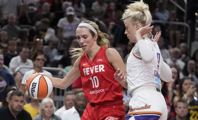 Indiana Fever's Lexie Hull (10) is defended by Phoenix Mercury's Sophie Cunningham, right, during the second half of a WNBA basketball game, Friday, Aug. 16, 2024, in Indianapolis. (AP Photo/Darron Cummings)