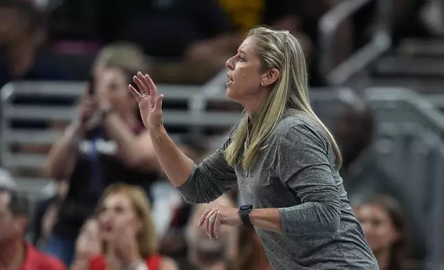 Indiana Fever head coach Christie Sides talks to players from the sidelines during the second half of a WNBA basketball game against the Phoenix Mercury, Friday, Aug. 16, 2024, in Indianapolis. (AP Photo/Darron Cummings)