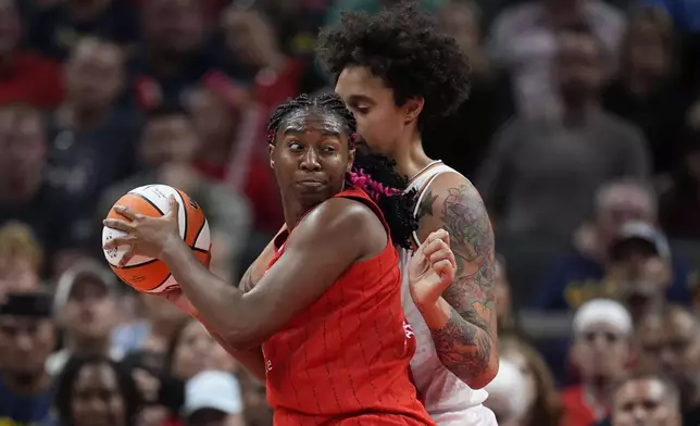 Indiana Fever forward Aliyah Boston, left, goes to the basket against Phoenix Mercury's Brittney Griner, right, during the first half of a WNBA basketball game, Friday, Aug. 16, 2024, in Indianapolis. (AP Photo/Darron Cummings)