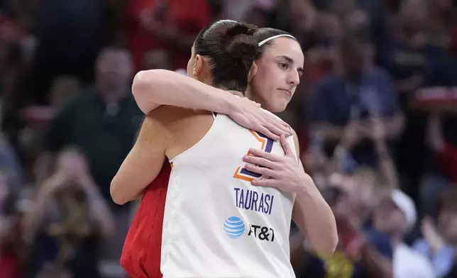 Indiana Fever guard Caitlin Clark hugs Phoenix Mercury's Diana Taurasi (3) before the first half of a WNBA basketball game, Friday, Aug. 16, 2024, in Indianapolis. (AP Photo/Darron Cummings)