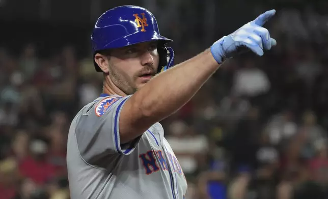 New York Mets' Pete Alonso points to the scoreboard in the first inning during a baseball game against the Arizona Diamondbacks, Tuesday, Aug 27, 2024, in Phoenix. (AP Photo/Rick Scuteri)