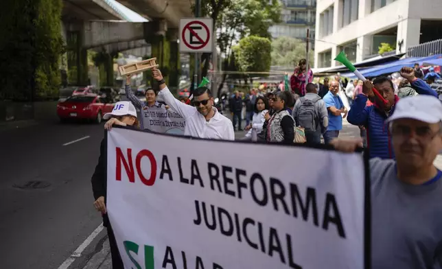 Unionized federal court workers strike over reforms that would make all judges stand for election, outside a federal court in Mexico City, Wednesday, Aug. 21, 2024. (AP Photo/Eduardo Verdugo)