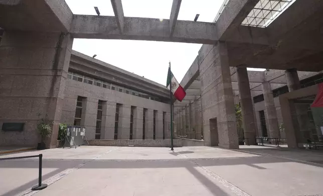 A Mexican flag stands amid the empty corridors of the federal court during a worker's strike over reforms that would make all judges stand for election in Mexico City, Monday, Aug. 19, 2024. (AP Photo/Fernando Llano)