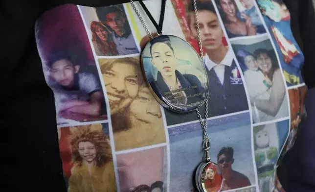 Photos of Veronica Rosas and her son Diego decorate Veronica's shirt and necklaces, as she poses for a portrait at her home in Ecatepec, Mexico, Friday, Aug. 2, 2024. Rosas' son went missing when he was 16 years old on Sept. 4, 2015. (AP Photo/Ginnette Riquelme)