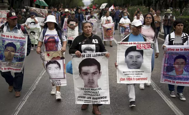 Relatives of the 43 Ayotzinapa students who went missing almost 10 years ago march to demand justice for their loved ones in Mexico City, Monday, Aug. 26, 2024. (AP Photo/Felix Marquez)