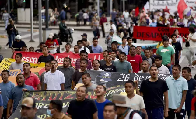 Classmates of the 43 Ayotzinapa students who went missing almost 10 years ago march to demand justice for their loved ones in Mexico City, Monday, Aug. 26, 2024. (AP Photo/Felix Marquez)