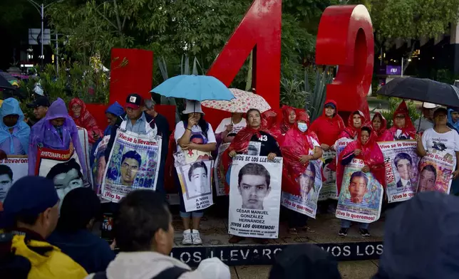 Relatives of the 43 Ayotzinapa students who went missing almost 10 years ago march to demand justice for their loved ones in Mexico City, Monday, Aug. 26, 2024. (AP Photo/Felix Marquez)