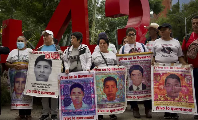 Relatives of the 43 Ayotzinapa students who went missing almost 10 years ago march to demand justice for their loved ones in Mexico City, Monday, Aug. 26, 2024. (AP Photo/Felix Marquez)