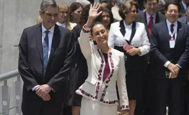 Mexican President-elect Claudia Sheinbaum, accompanied by husband Jesus Maria Tarriba, waves as she leaves a ceremony certifying her as the winner of the presidential election, at the Federal Electoral Tribunal in Mexico City, Thursday, Aug. 15, 2024. (AP Photo/Fernando Llano)