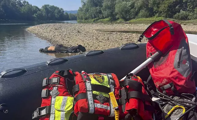 A body lies near the Drina River by the town of Bratunac, Bosnia, Thursday, Aug. 22, 2024. (AP Photo)