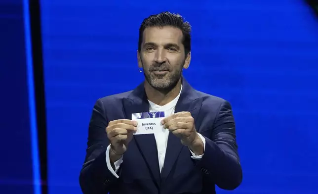 Former Italian goalkeeper Gianluigi Buffon holds a ticket for Juventus during the Champions League, league phase, draw, in Monaco, Thursday, Aug. 29, 2024. (AP Photo/Gregorio Borgia)