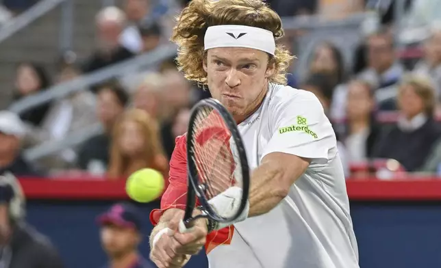 Andrey Rublev, of Russia, plays a shot to Alexei Popyrin, of Australia, during the final of the National Bank Open men's tennis tournament in Montreal, Monday, Aug. 12, 2024. (Graham Hughes/The Canadian Press via AP)