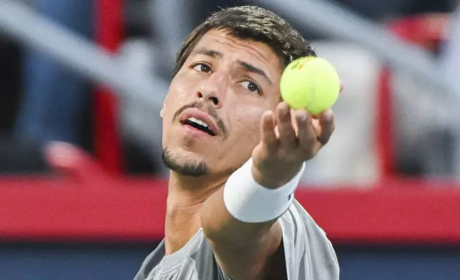 Alexei Popyrin, of Australia, serves to Andrey Rublev, of Russia, during the final of the National Bank Open men's tennis tournament in Montreal, Monday, Aug. 12, 2024. (Graham Hughes/The Canadian Press via AP)