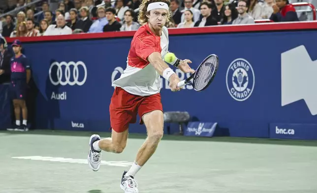 Andrey Rublev, of Russia, plays a shot to Alexei Popyrin, of Australia, during the final of the National Bank Open men's tennis tournament in Montreal, Monday, Aug. 12, 2024. (Graham Hughes/The Canadian Press via AP)