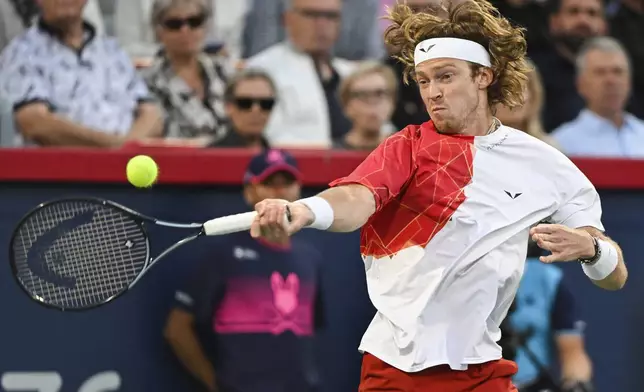 Andrey Rublev, of Russia, plays a shot to Alexei Popyrin, of Australia, during the final of the National Bank Open men's tennis tournament in Montreal, Monday, Aug. 12, 2024. (Graham Hughes/The Canadian Press via AP)