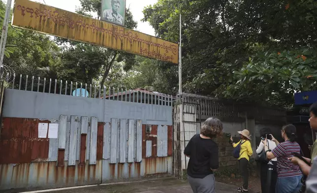 Journalists gather outside the residence of ousted leader Aung San Suu Kyi as the home is auctioned in Yangon, Myanmar Thursday, Aug. 15, 2024. (AP Photo/Thein Zaw)