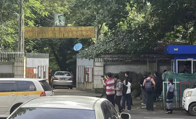 Journalists gather outside the residence of ousted leader Aung San Suu Kyi as the home is auctioned in Yangon, Myanmar Thursday, Aug. 15, 2024. (AP Photo/Thein Zaw)