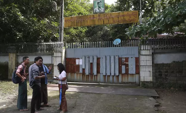 Journalists gather outside the residence of ousted leader Aung San Suu Kyi as the home is auctioned in Yangon, Myanmar Thursday, Aug. 15, 2024. (AP Photo/Thein Zaw)