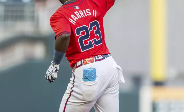 Atlanta Braves' Michael Harris II rounds second and waves to the crowd after hitting a home run in the first inning of a baseball game against the Washington Nationals, Friday, Aug. 23, 2024, in Atlanta. (AP Photo/Jason Allen)