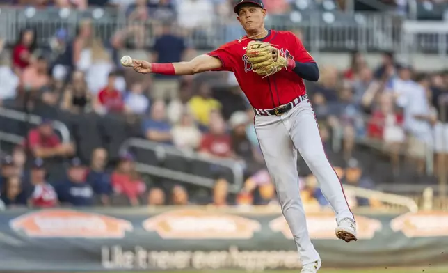 Atlanta Braves third baseman Gio Urshela throws out a Washington Nationals runner at first base in the first inning of a baseball game Friday, Aug. 23, 2024, in Atlanta. (AP Photo/Jason Allen)