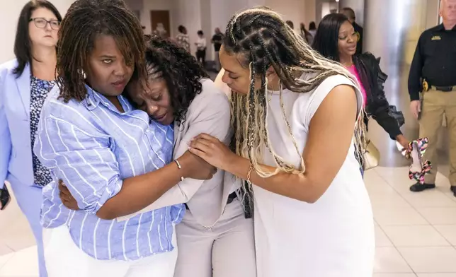 Pamela Dias, center, Ajike “A.J.” Owens' mother, is consoled by friends and family outside the courtroom after a jury found Susan Lorincz guilty of manslaughter in the shooting death of her daughter, Friday afternoon, Aug. 16, 2024, in Ocala, Fla. (Doug Engle/Ocala Star-Banner via AP, Pool)