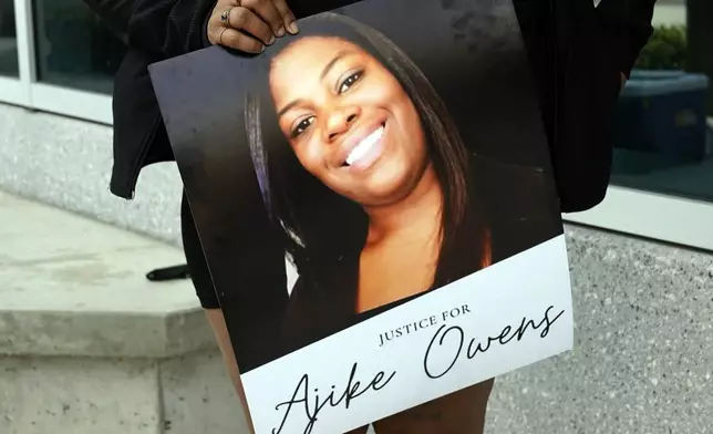 FILE - A protester holds a poster of Ajike Owens and demands the arrest of a woman who killed her during a rally at the Marion County Courthouse, June 6, 2023, in Ocala, Fla. (AP Photo/John Raoux, File)