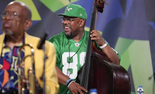 Bassist Christian McBride, right, performs during the Newport Jazz Festival, Sunday, Aug. 4, 2024, in Newport, R.I. Trombonist Fred Wesley sits at left. (AP Photo/Steven Senne)