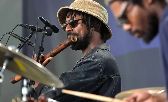 Shabaka Hutchings, center, performs during the Newport Jazz Festival, Sunday, Aug. 4, 2024, in Newport, R.I. (AP Photo/Steven Senne)