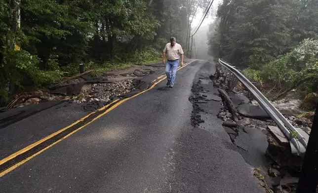 Skip Kearns, with the Connecticut Department of Energy and Environmental Protection, looks over damage on Georges Hill Rd., in Southbury, Conn., Monday, Aug. 19, 2024. ( Jim Michaud/Hearst Connecticut Media via AP)